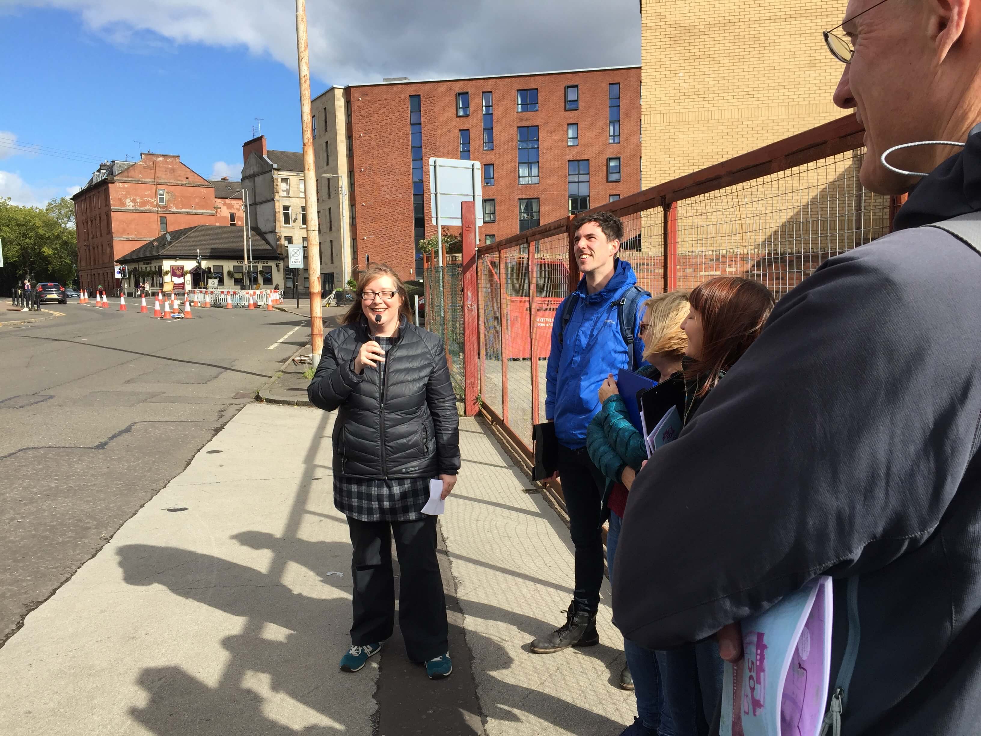 Gaelic author Maureen NicLeòid speaking about life in Glasgow and reading from her work on a stop of the walking tour