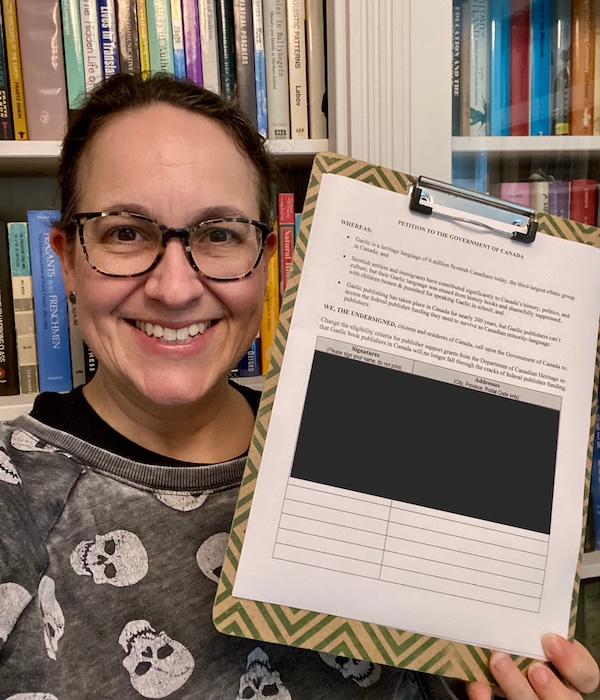 Emily McEwan with the paper version of the petition (names redacted)